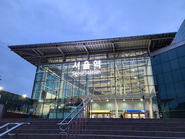 서울역의 유리 외관과 역명 표지가 보이는 전경으로, 공항철도 이용 후 환승 동선의 규모를 떠올리게 한다。